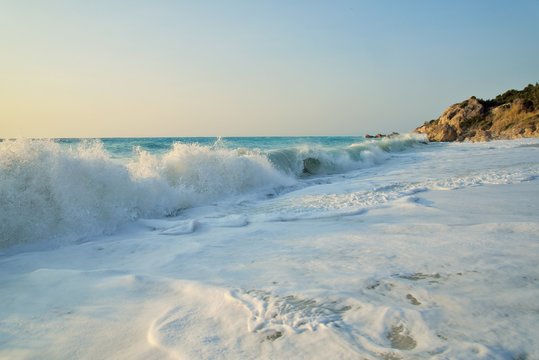 Enormous waves crashing on the shore and on the rocks at the Megali Patra Beach at the sunset, Lefkada Island, Greece