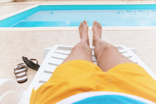 Man Enjoying The Summer By The Pool.