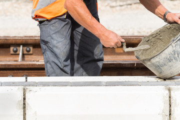 Construction worker working hard and leveling concrete pavement outdoors.