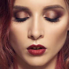 Portrait of woman with long curly beautiful ginger hair.