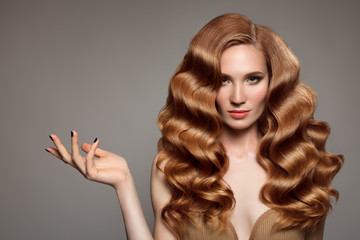 Portrait of woman with long curly beautiful ginger hair.