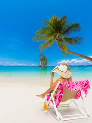 Woman sitting on a chair at the beach
