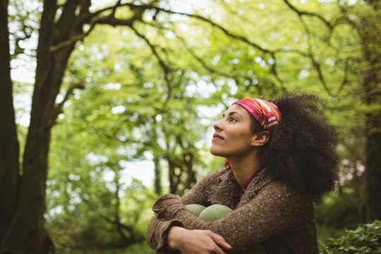 Thoughtful woman at forest
