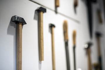 hammers and other tools hanging on wall