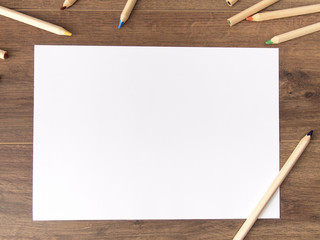 Empty white sheet on dark wooden background