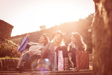 Three best friend after shopping. Three best friends roasting on the stairs after shopping having...
