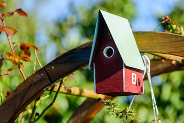 Homemade red and white nesting box or birdhouse.