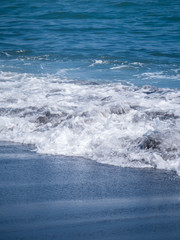 Black volcanic beach in eastern Bali Indonesia