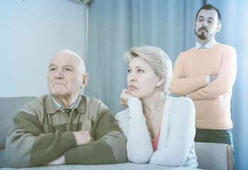 Man seriously talking with family