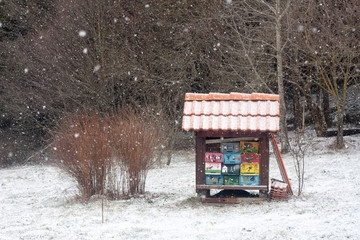 Small colorful beehive in snowfall, Cerknica, Slovenia.