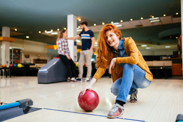 Fototapeta premium Friends having fun while bowling