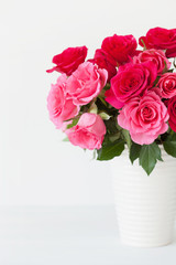 beautiful red rose flowers bouquet in vase over white