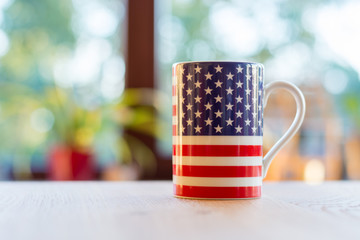 Flag of the United States of America on a mug close up and blurry background