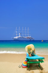 Woman sitting on a chair at the beach