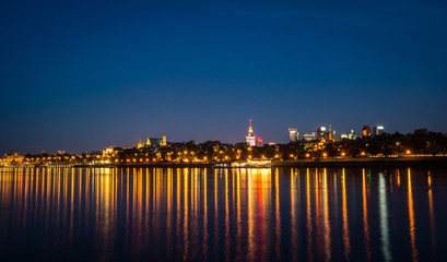 Panorama of Warsaw city over Vistula river at night, Poland
