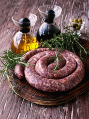 raw beef sausages on a cast-iron pan, selective focus