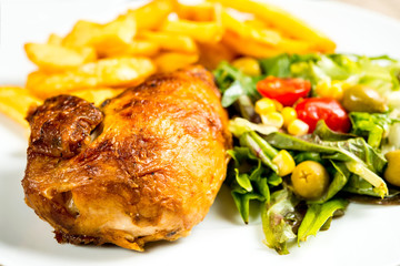 chicken and French fries on white plate