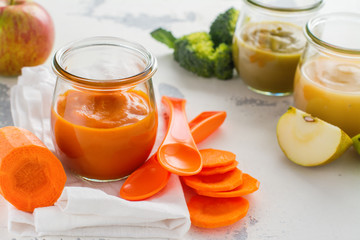 Homemade carrot puree with ingredients on white background. Space for text