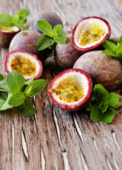 juicy fruit Granadilla with mint on a wooden table