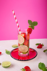 Fresh lemonade with strawberries, lime and mint