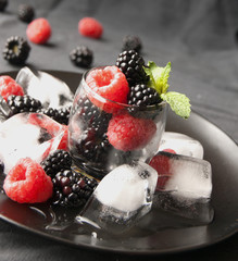 black berries and raspberries in a glass cup