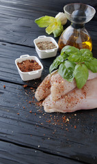 raw chicken breasts with herbs spices