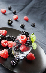 black berries and raspberries in a glass cup