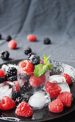 black berries and raspberries in a glass cup