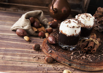 hot chocolate in glass cups and cream with nuts