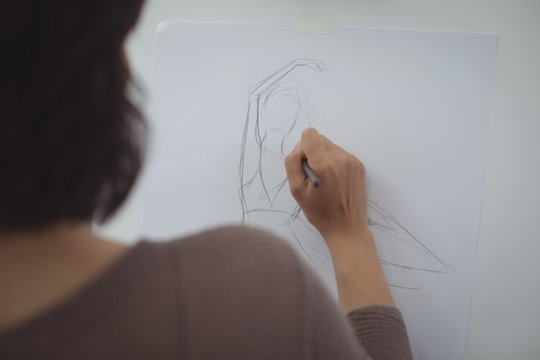 Artist drawing sketch on canvas