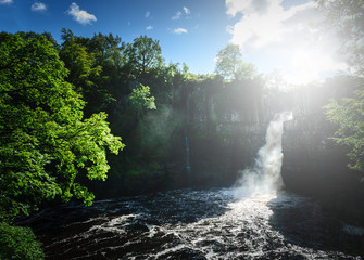 Fototapeta premium High Force Waterfall views from the south bank of the River Tees on the Pennine Way in woodland, UK.