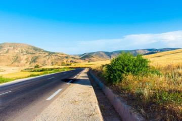 road through the mountain ,summer time ,sunny day ,blue sky