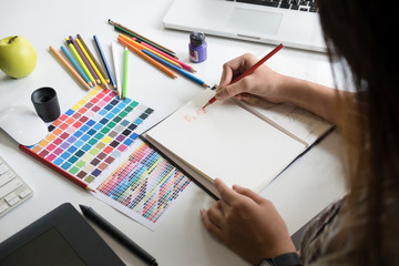Artist creative graphic designer working on creative desk.