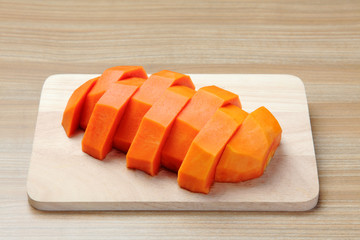 peeled papaya on the wooden cutting board