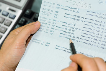 Account book bank and calculator on table.
