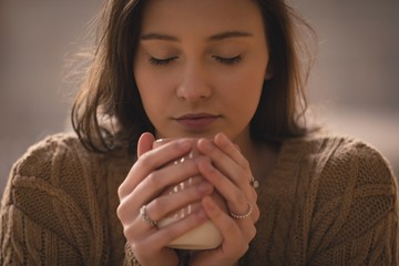 Woman smelling the aroma of coffee