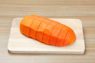 peeled papaya on the wooden cutting board