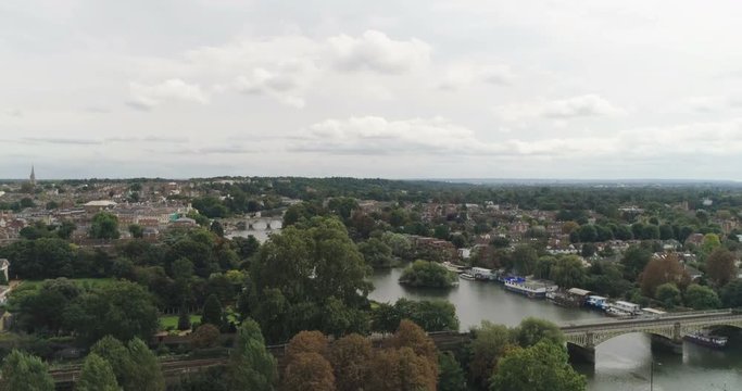 Aerial ascending view over residential Victorian villages by the river Thames in West London