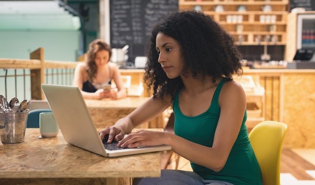 Woman using laptop in café