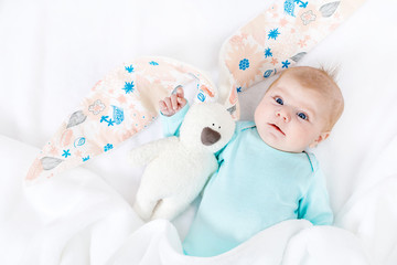 Adorable cute newborn baby girl with Easter bunny toy