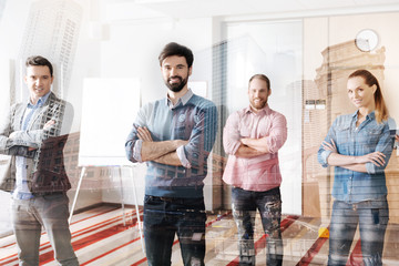 Fototapeta premium Optimistic team keeping arms in crossed position
