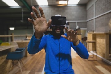 Man looking through virtual reality simulator in cafeteria