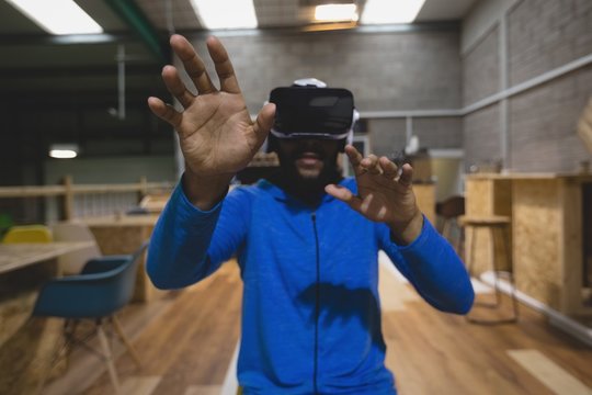 Man looking through virtual reality simulator in cafeteria