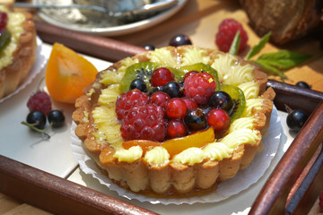 Berry tasty tart with raspberry, redcurrant, blackcurrant, peach, kiwi, cherry closeup