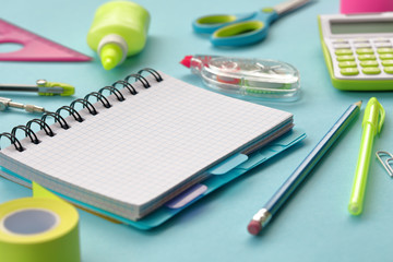 Stationery and office supplies on a blue paper background