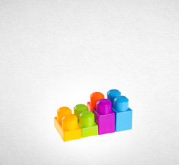 Plastic building blocks or colour blocks on a background.