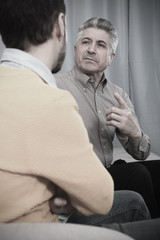 Adult father and son solve problems