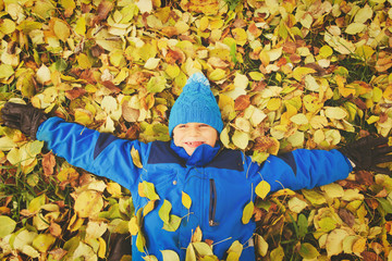 happy teenage boy play in autumn fall