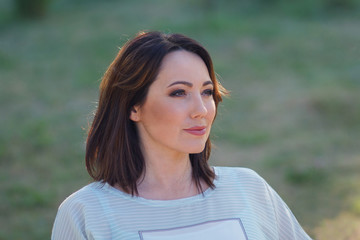 Portrait of a beautiful woman in the garden. People