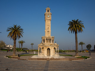 Fototapeta premium Doves and walking people on Konak Square near the historical clock tower